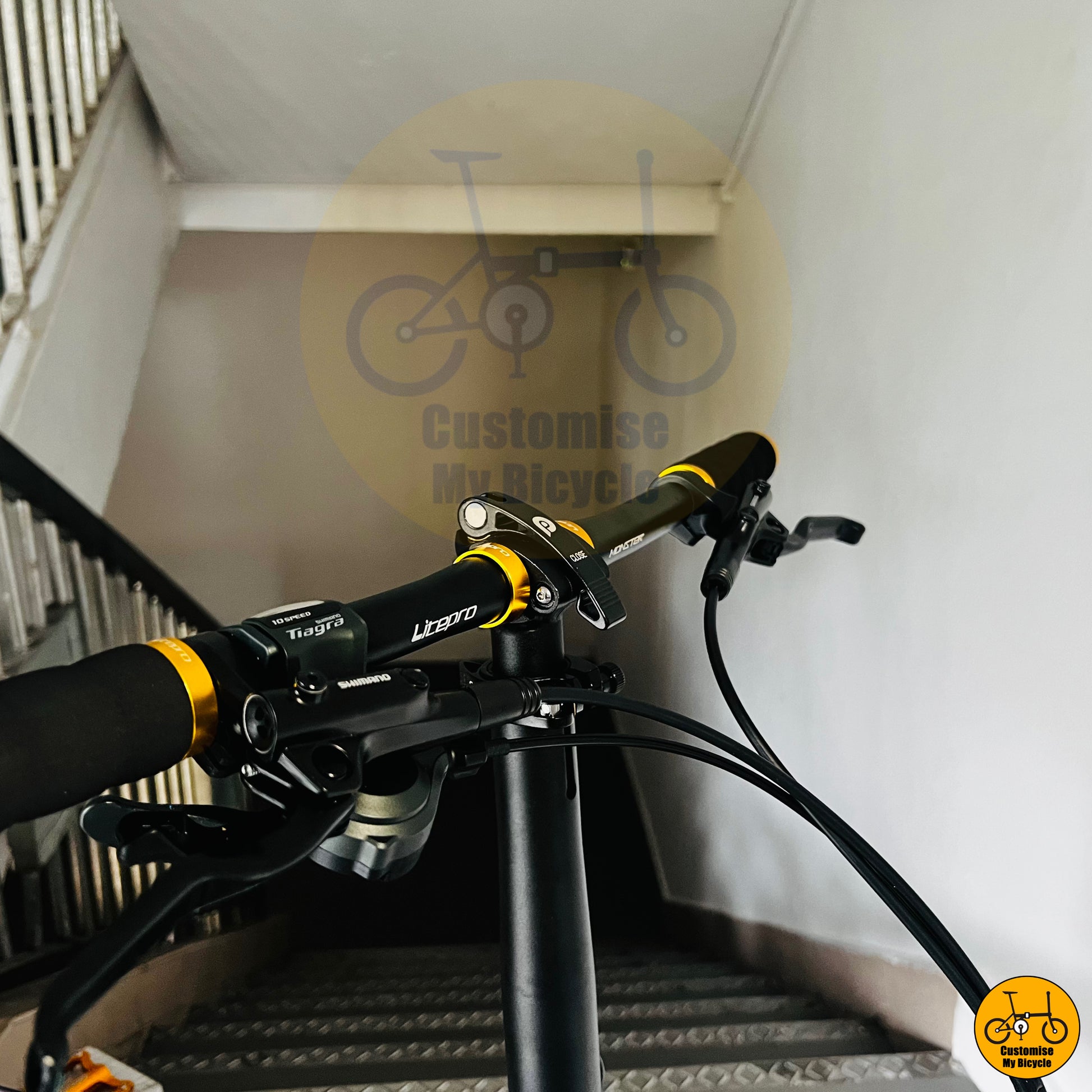 Gold pedals and ergonomic handlebars on Crius Velocity 22-inch folding bicycle
