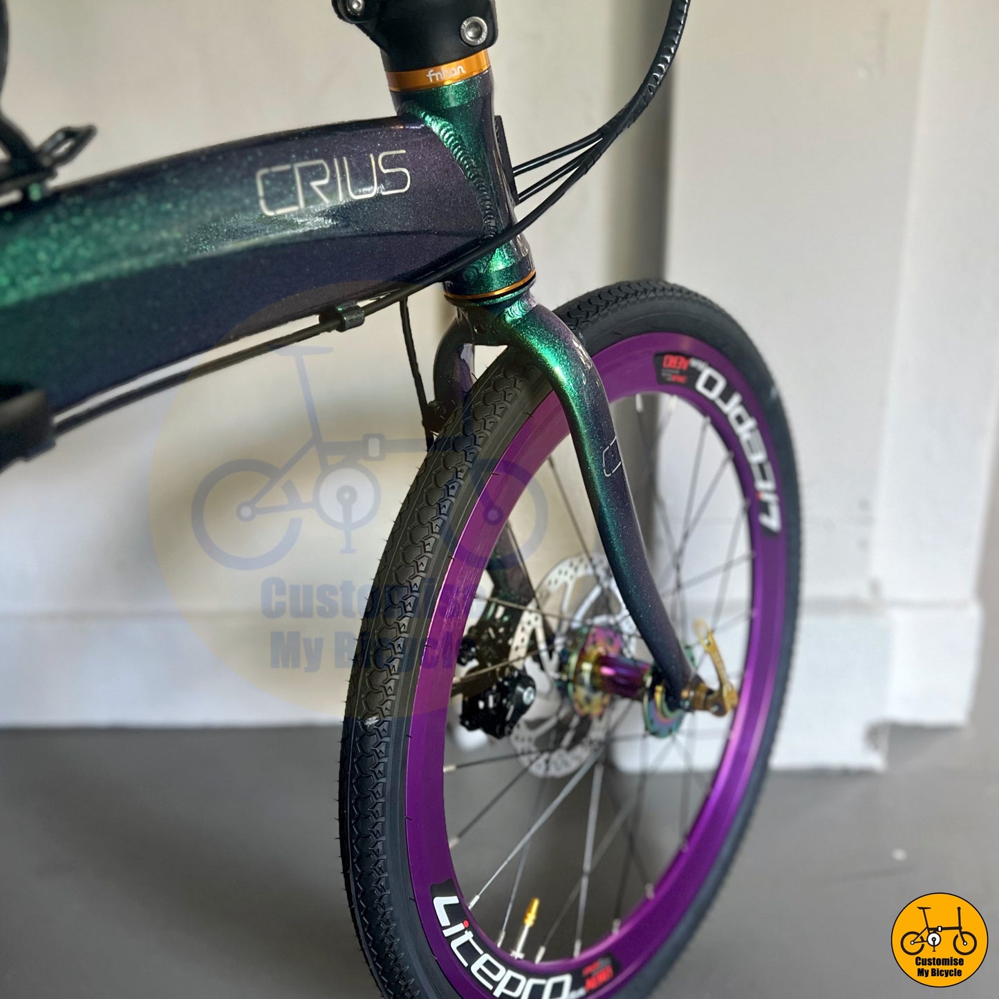 Premium foldable bicycle with purple deep-section wheels and a sleek design
