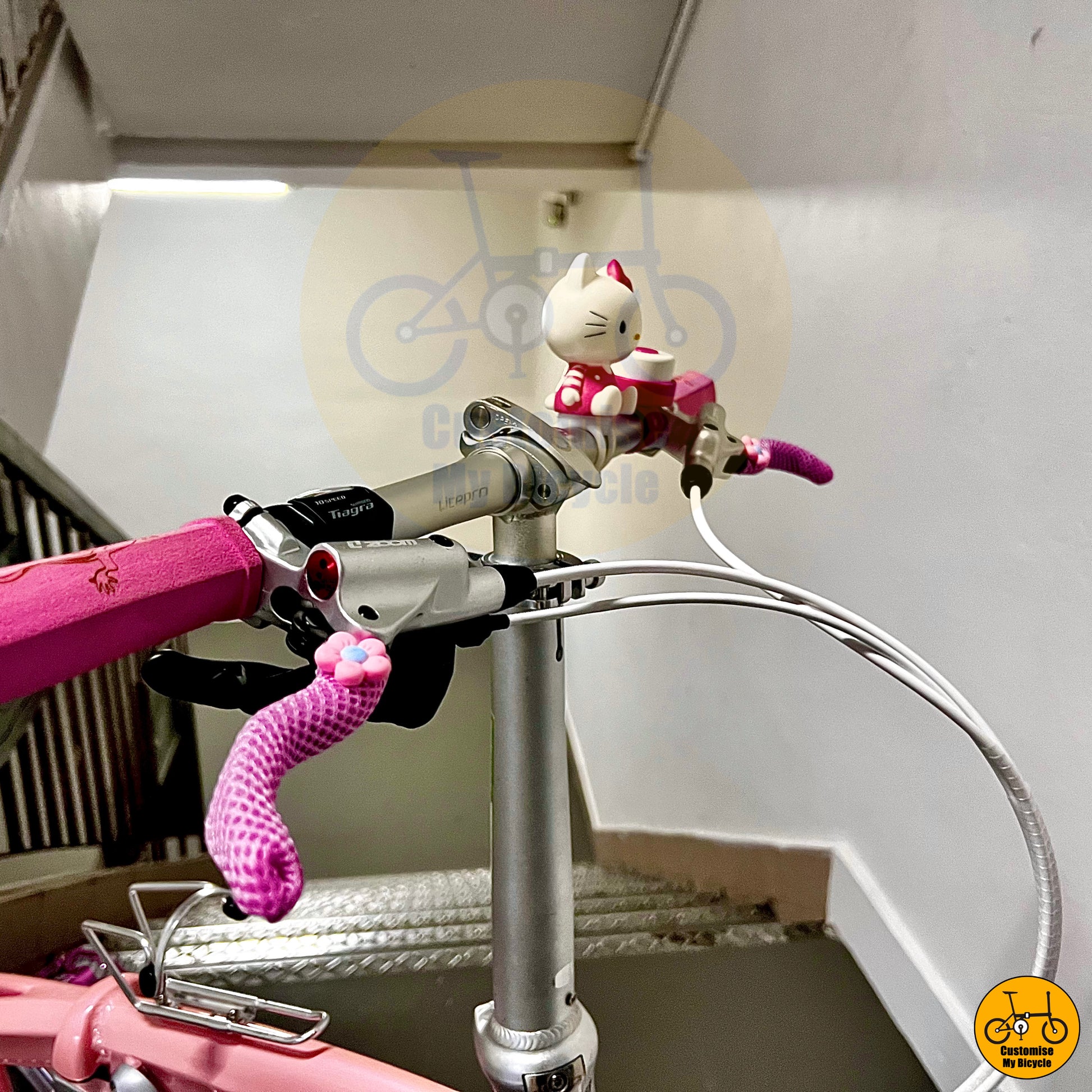 Hello Kitty-themed handlebars with ergonomic grips on Crius Velocity folding bike
