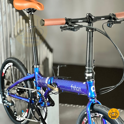 Folding bike with brown retro saddle
