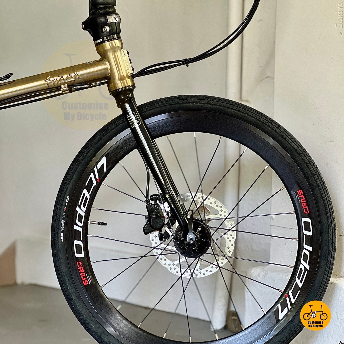 Front wheel close up showing Litepro Aero high profile rims and Maxxis 451 tyres
