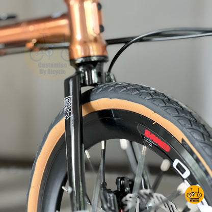 Front wheel low-angle shot displaying LITEPRO Aero 349 rims and brown tyres under natural light