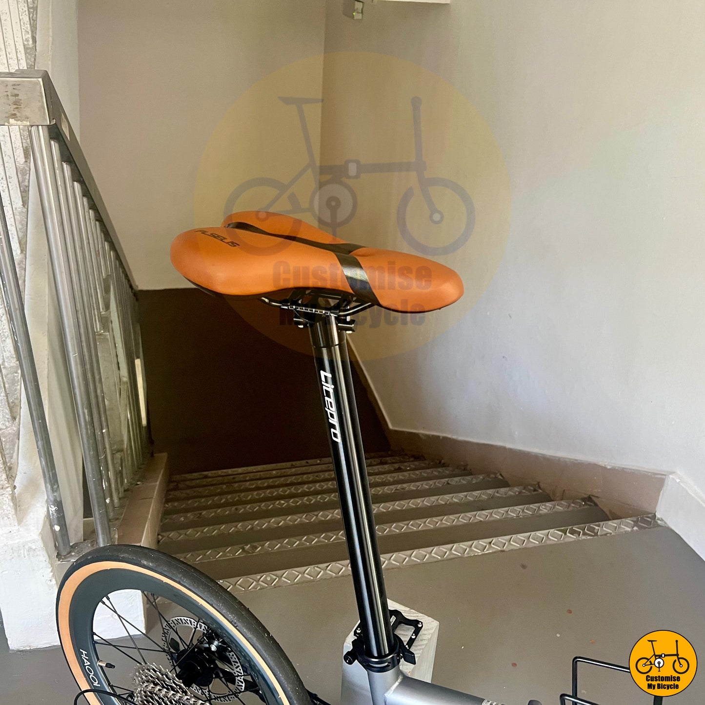 Stylish battleship grey folding bike with comfortable brown saddle
