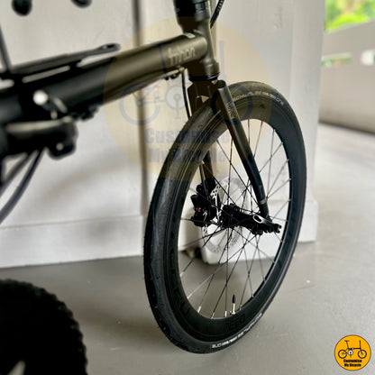 Schwalbe One 451 tyres on all-black lightweight folding bike for effortless city navigation
