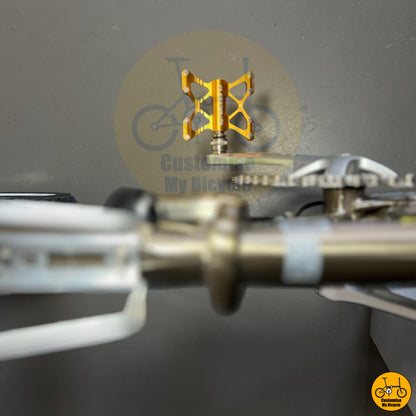 Litepro K5 quick release pedals on folding bicycle with an elegant titanium gold frame and polished parts
