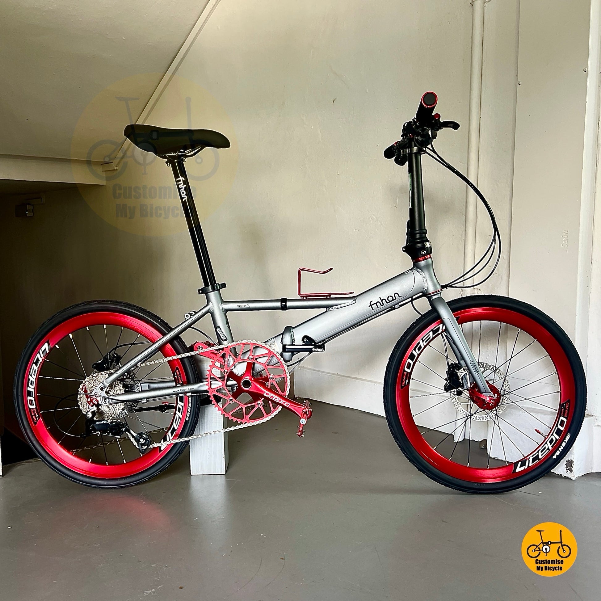Lightweight foldable Fnhon Monsoon bike in battleship grey with red wheels
