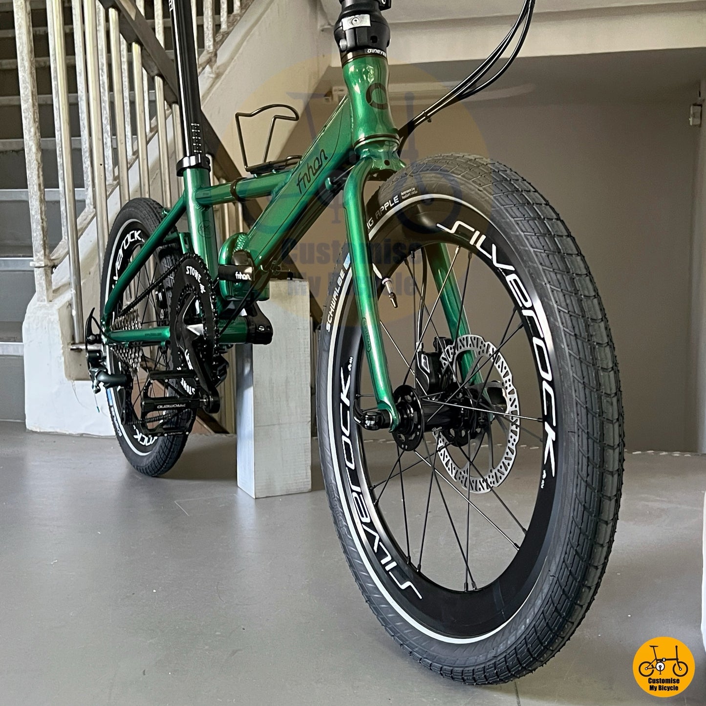 Fnhon Monsoon folding bicycle Emerald Green urban commuter folding bike pavement riding view
