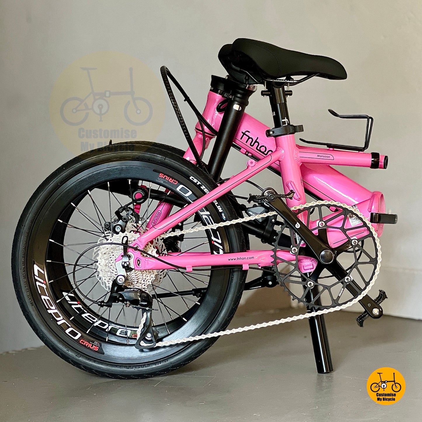 Full folded bike view showcasing Hot Pink frame and aero wheelset