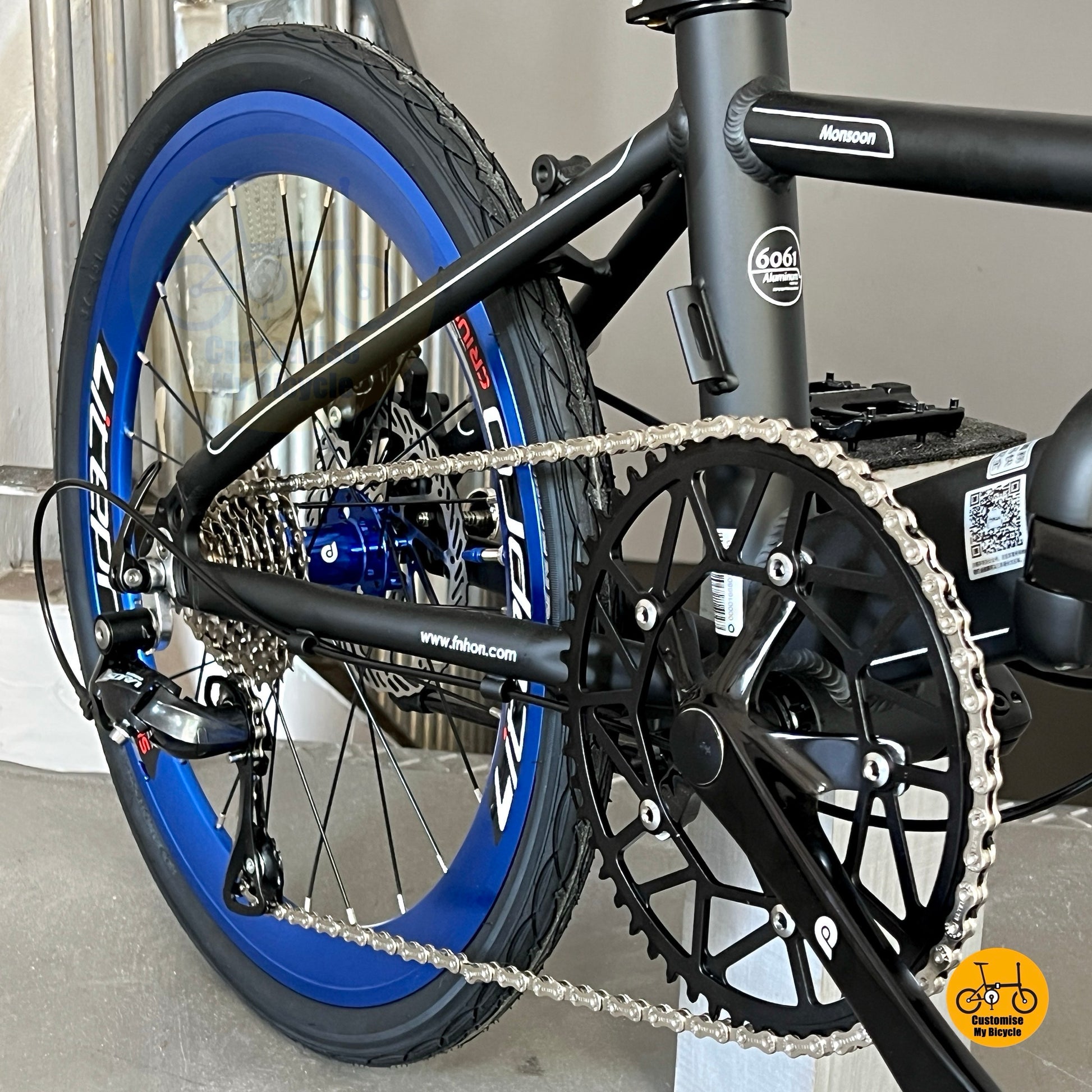 Close up of Fnhon Litepro Hollowtech crankset and hollow 54t chainring Matte Black Blue Monsoon

