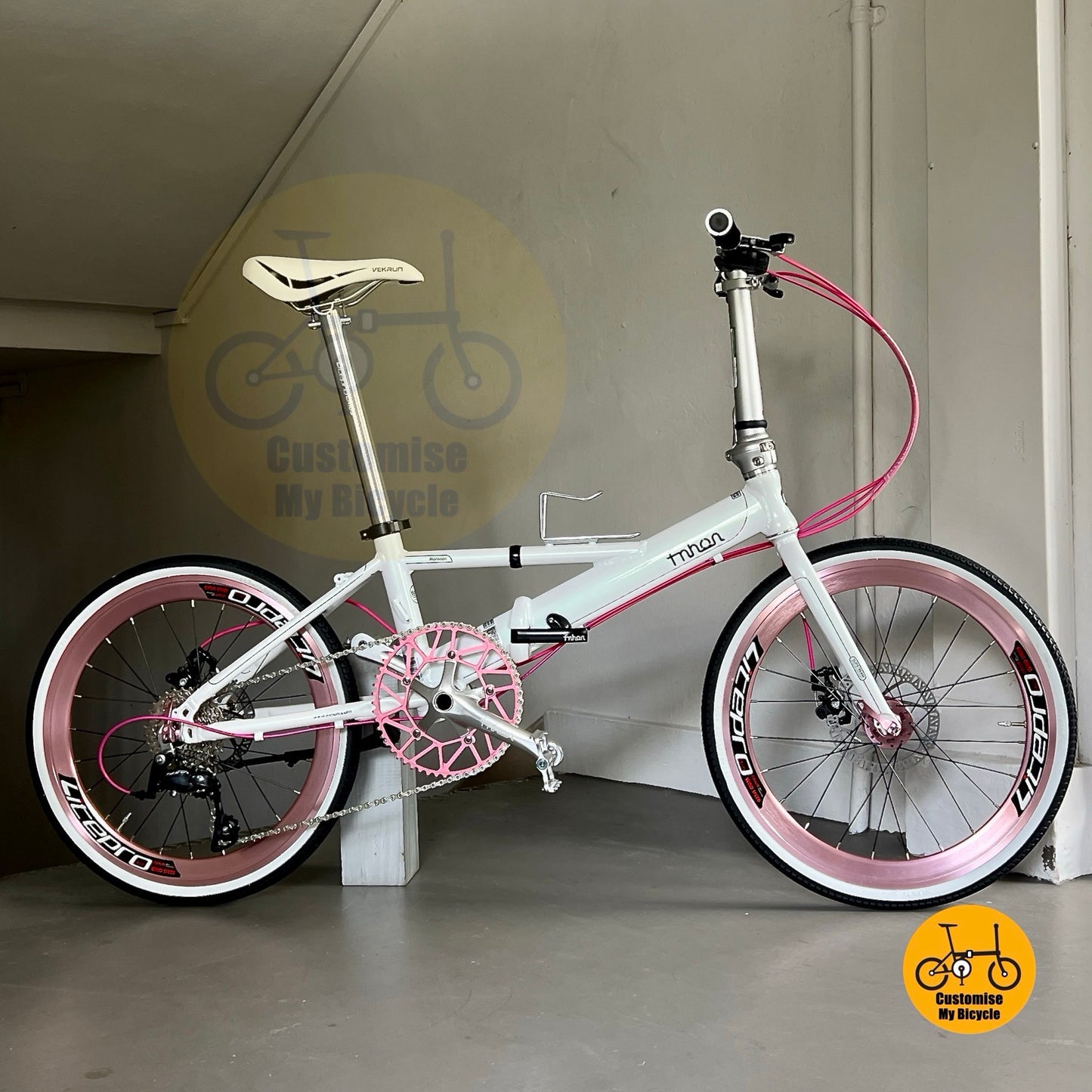 Folding bicycle in white pink with INNOVA tyres and adjustable handle post
