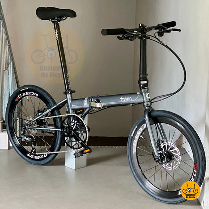 Folding bicycle on a stand with a plain background