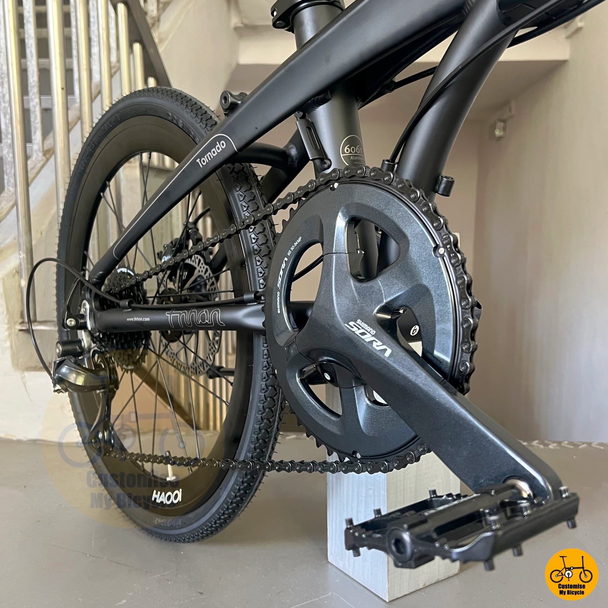 Side profile of batman-themed folding bike in matte black
