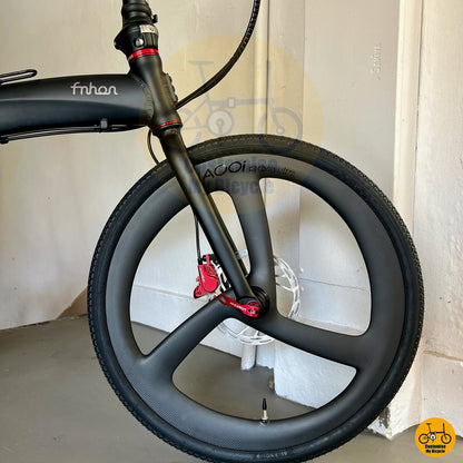 Matte black foldie with 3-spoke aero wheels and dolphin-inspired frame shape
