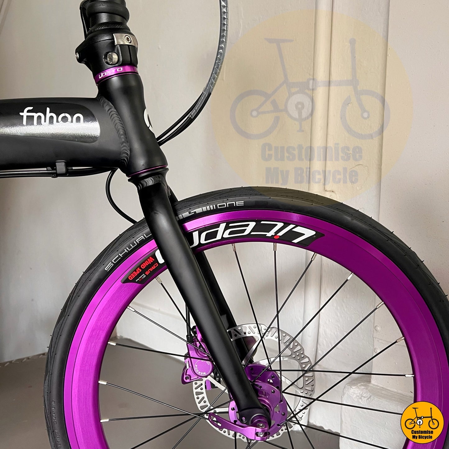 folding bicycle with matte black frame and violet rims

