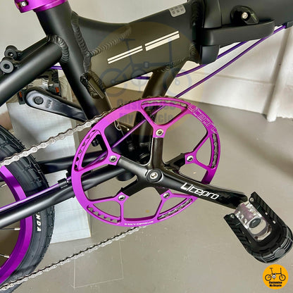 Foldable city bicycle with stylish purple chainring and cabling
