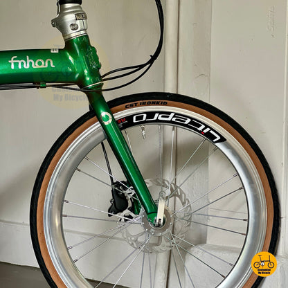 Front wheel close up showing Litepro Aero rims on Fnhon Wind 22 inch Emerald Green bicycle  
